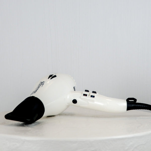 White hair dryer with black accents on a white background