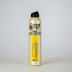 Gold fire extinguisher with black cap on a white background