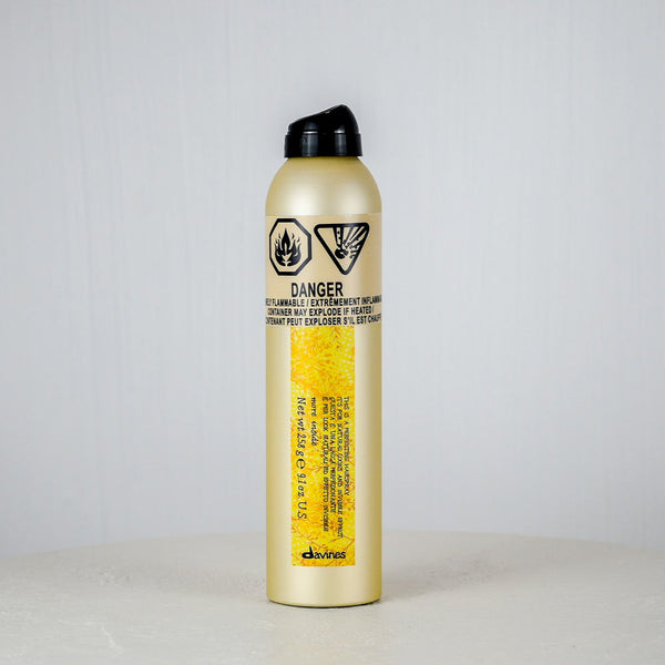 Gold fire extinguisher with black cap on a white background