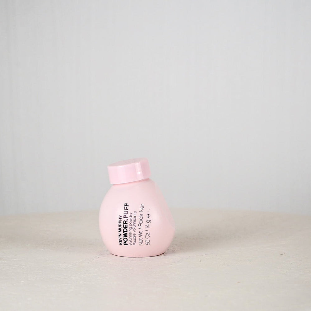 Pink bottle with text on a light gray background