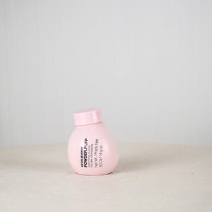 Pink bottle with text on a light gray background