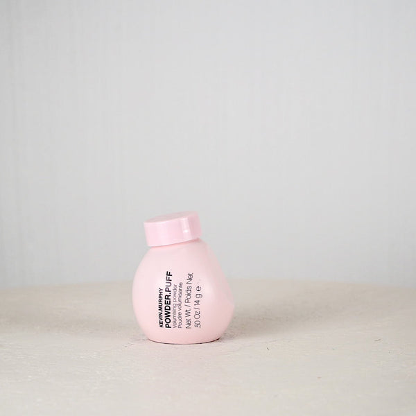 Pink bottle with text on a light gray background