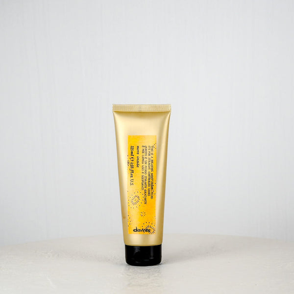Tube of Davines hair product on a white background