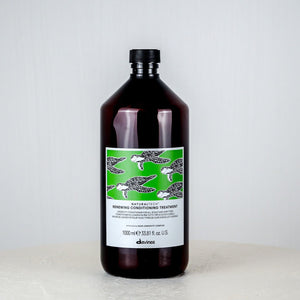 Bottle of Davines hair product on a white surface with a light gray background