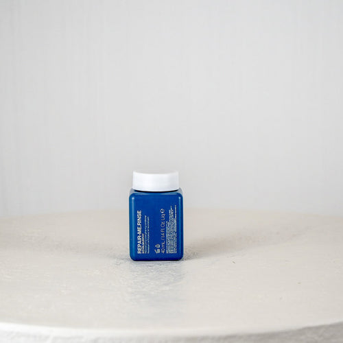 Blue container with white cap on a white surface