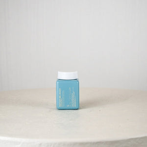 Small blue container with white lid on a light gray surface
