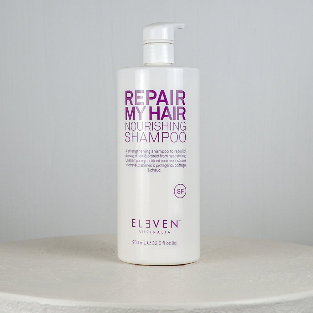 Shampoo bottle labeled 'Repair My Hair Nourishing Shampoo' by 'Eleven Australia' on a white background