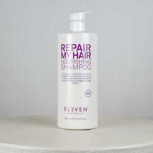 Shampoo bottle labeled 'Repair My Hair Nourishing Shampoo' by Eleven Australia on a neutral background