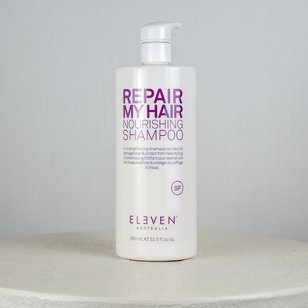 Shampoo bottle labeled 'Repair My Hair Nourishing Shampoo' by Eleven Australia on a neutral background