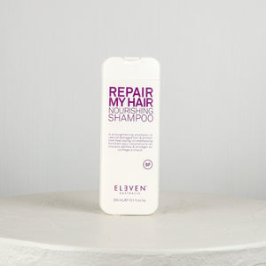 Shampoo bottle labeled 'Repair My Hair Nourishing Shampoo' by 'Eleven Australia' on a white background