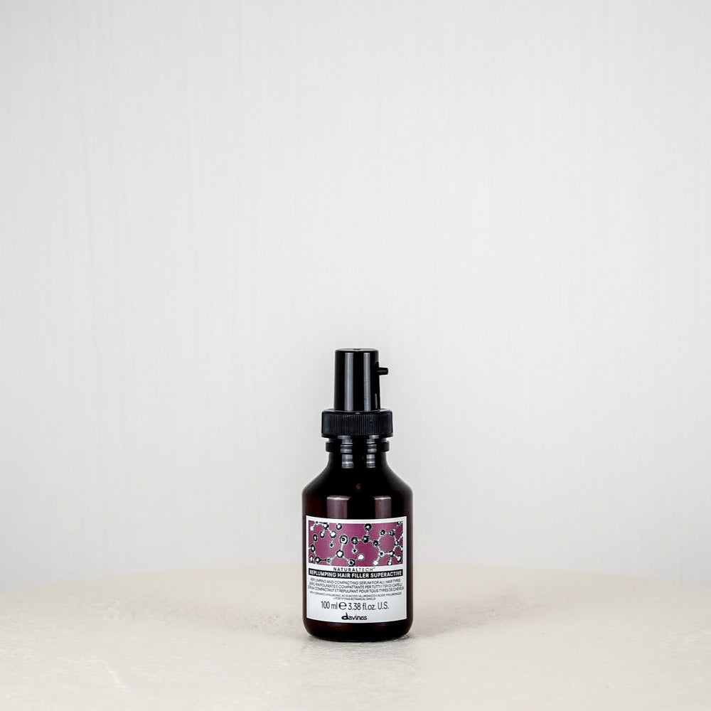 Skincare bottle with a purple label on a white background