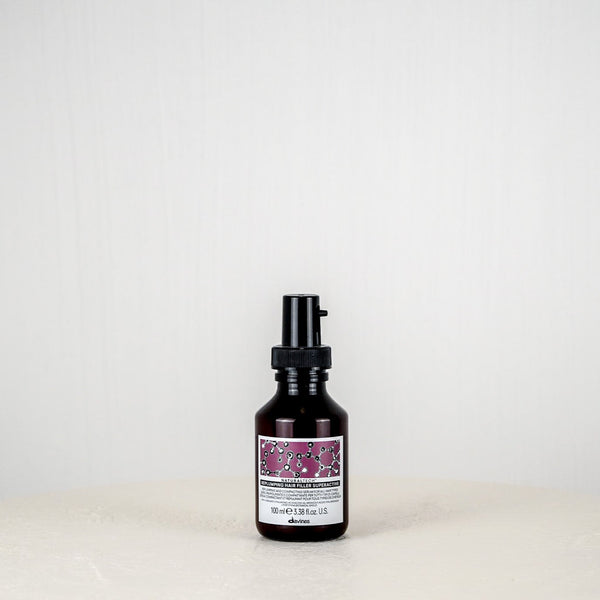 Skincare bottle with a purple label on a white background