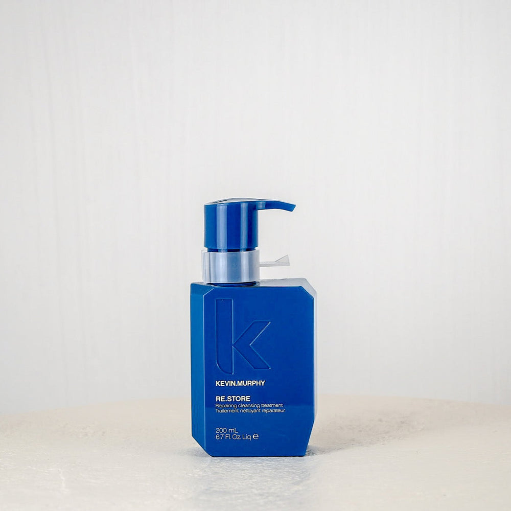 Blue bottle with pump on a white surface and background