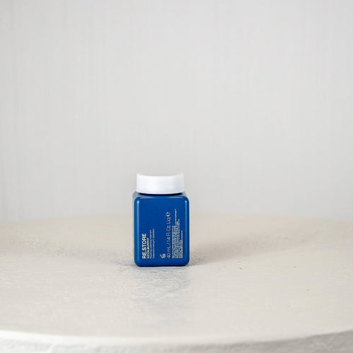 Blue container with white cap on a white surface