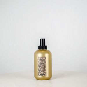 Gold bottle with black cap on a white background