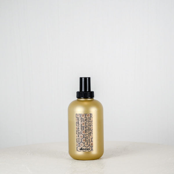 Gold bottle with black cap on a white background