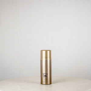 Skincare bottle on a white surface with a light gray background