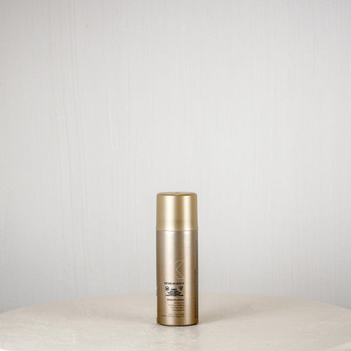 Skincare bottle on a white surface with a light gray background