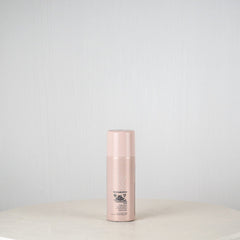 Skincare bottle on a white surface with a light gray background