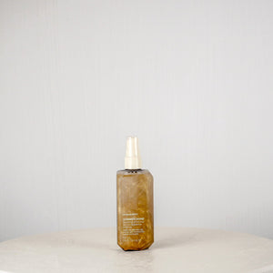 Skincare bottle on a white surface with a gray background