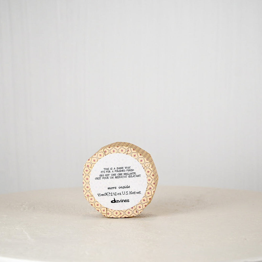 Round container with a label on a white surface