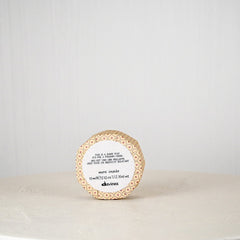Round container with a label on a white surface
