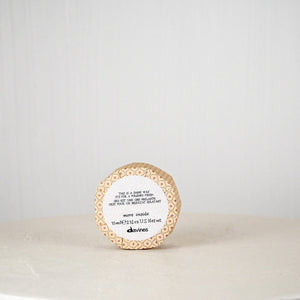 Round container with a label on a white surface