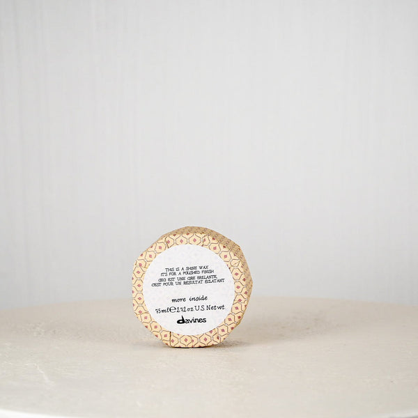 Round container with a label on a white surface