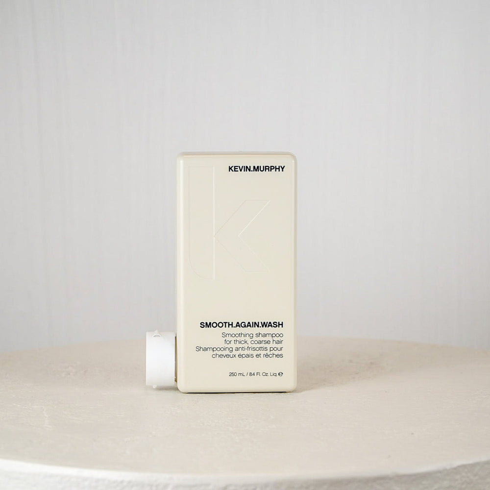 Kevin Murphy shampoo bottle on a white surface with a gray background