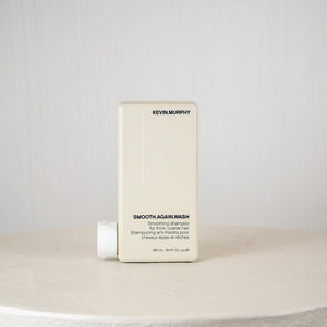 Kevin Murphy shampoo bottle on a white surface with a gray background