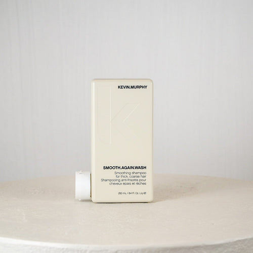 Kevin Murphy shampoo bottle on a white surface with a gray background