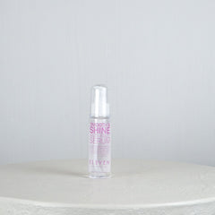 Bottle of 'Smooth & Shine Hair Serum' by 'Eleven' on a white surface with a light gray background