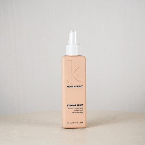 Kevin Murphy hair product bottle on a white surface with a light gray background