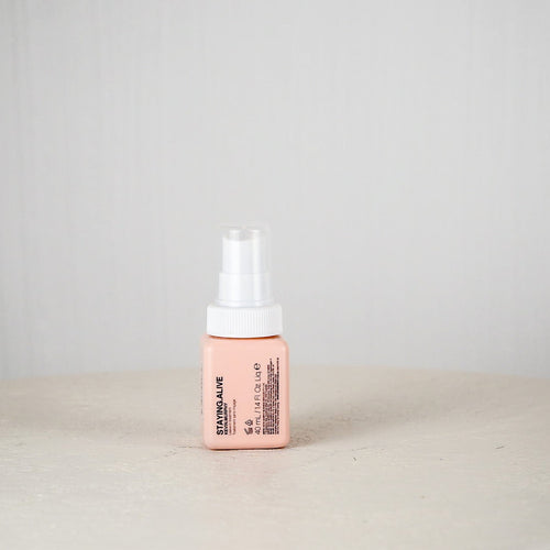 Pink bottle with white cap on a light gray background