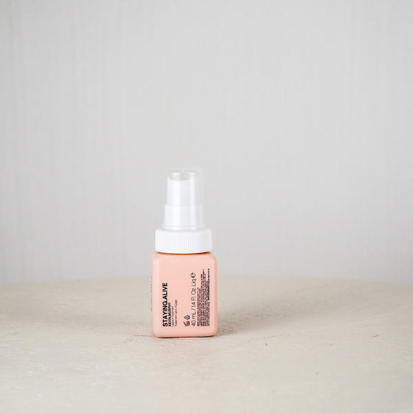 Pink bottle with white cap on a light gray background