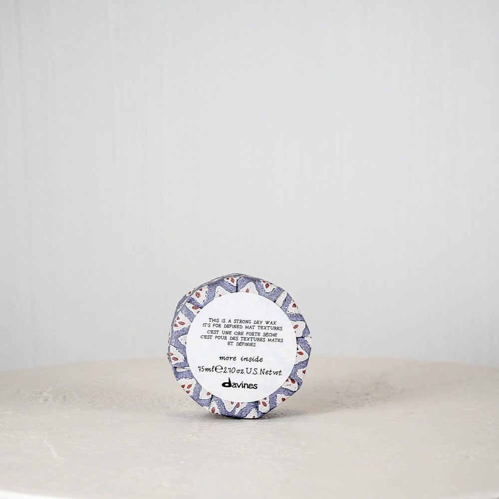 Round container with a decorative label on a white surface