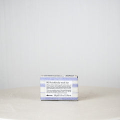 Bar of soap with a blue and white label on a white background