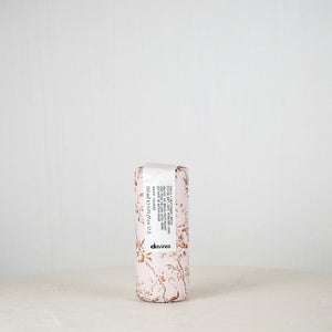 Skincare product with floral design on a white background