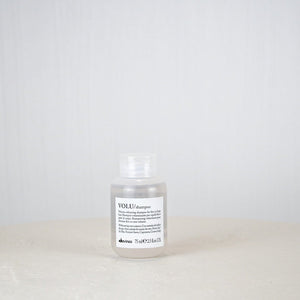 Shampoo bottle labeled 'VOLU' on a white background