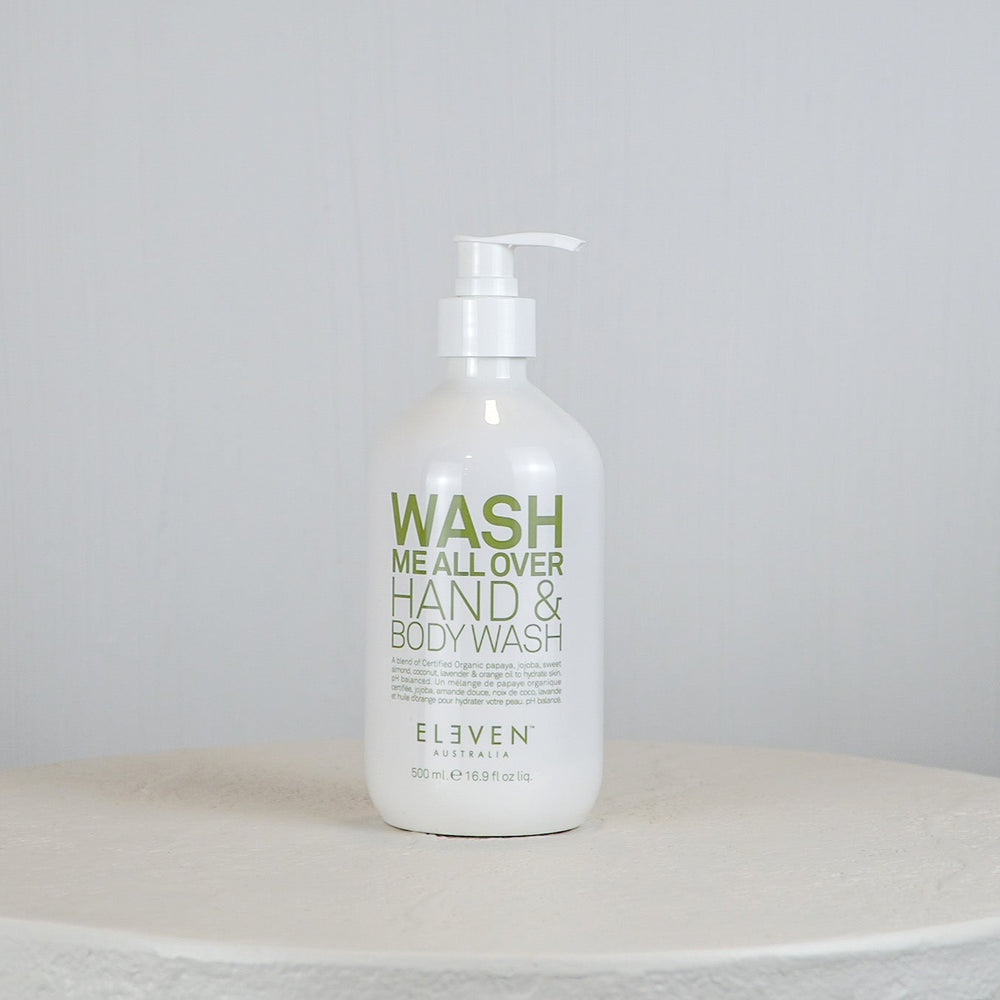 Hand and body wash bottle labeled 'Wash Me All Over' on a white surface with a light gray background