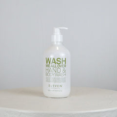 Hand and body wash bottle labeled 'Wash Me All Over' on a white surface with a light gray background