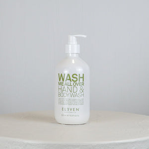 Hand and body wash bottle labeled 'Wash Me All Over' on a white surface with a light gray background