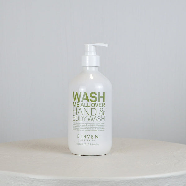 Hand and body wash bottle labeled 'Wash Me All Over' on a white surface with a light gray background