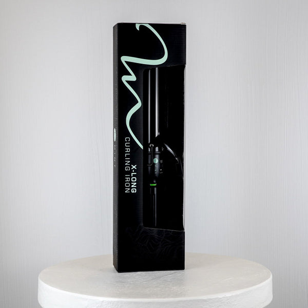 Black packaging of a curling iron on a white platform with a light gray background