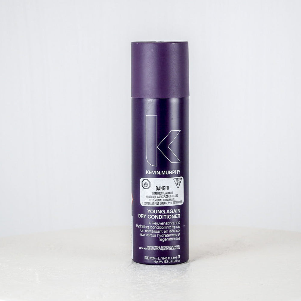 Purple bottle of Kevin Murphy conditioner on a white background