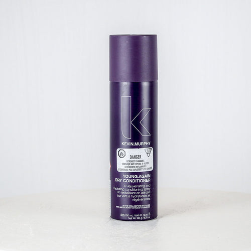 Purple bottle of Kevin Murphy conditioner on a white background