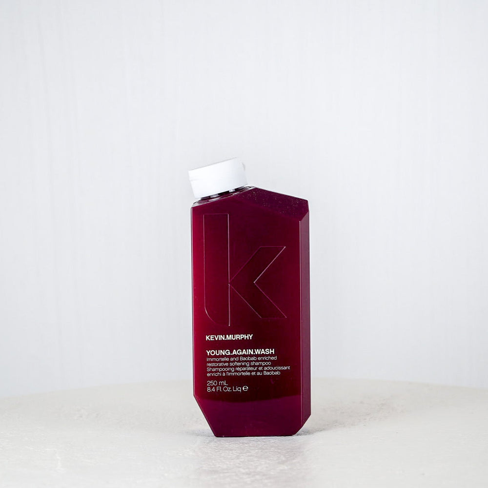 Kevin Murphy hair product bottle on a white surface with a white background