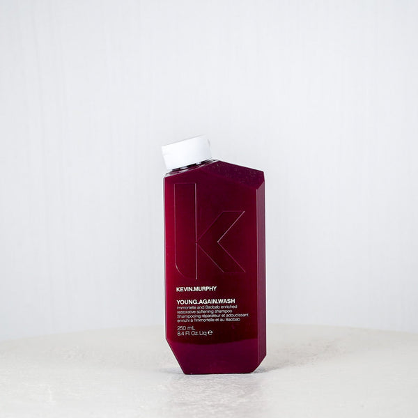 Kevin Murphy hair product bottle on a white surface with a white background